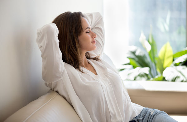 This image shows a woman relaxing on a sofa.