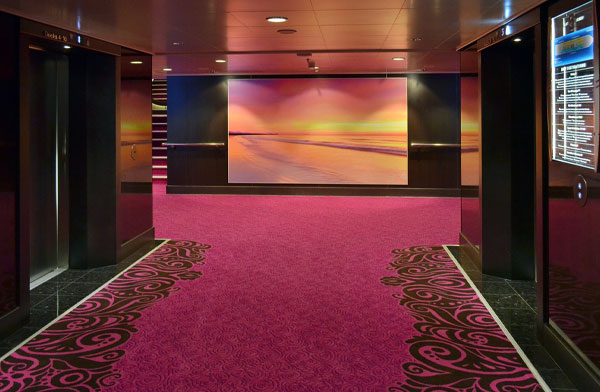 This image shows a hallway of a commercial building with carpet.