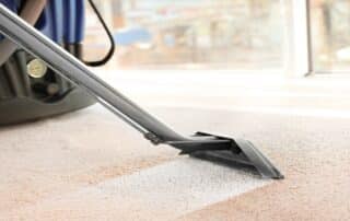 This image show a vacuum machine being used to clean the carpet.
